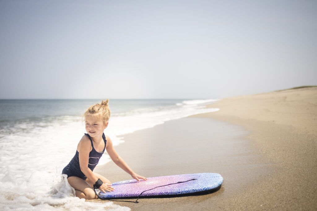 Little girl playing in the surf at Great Point, Nantucket