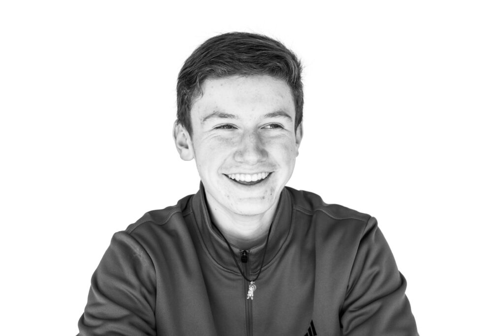 Teenage boy smiling naturally during personality portrait session 