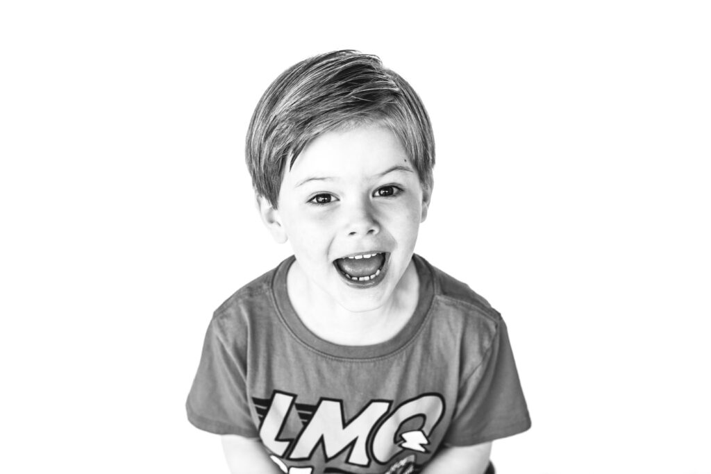 Five year old boy laughing during personality portrait session